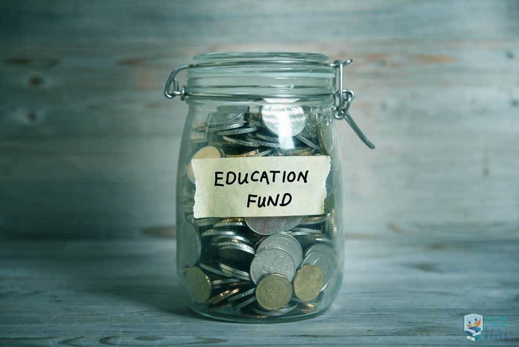 Saving money in a jar labeled "Education Fund" for college expenses and funding options.